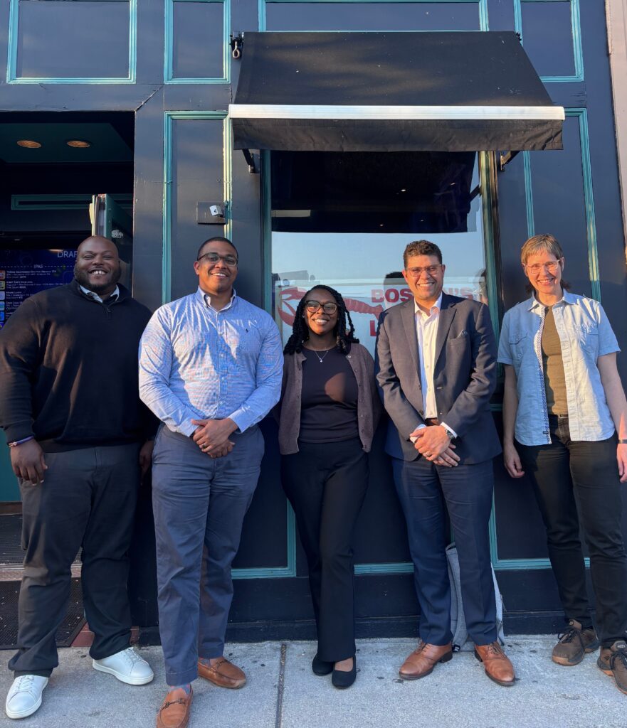5 NSIA Staff Team members standing outside on the street in Boston in Spring